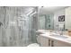 Modern bathroom with a large shower, marble-look tile, and white vanity at 4621 Gulf Of Mexico Dr # 16B, Longboat Key, FL 34228