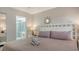 Main bedroom with king bed, ensuite bath access, and a ceiling fan at 4621 Gulf Of Mexico Dr # 16B, Longboat Key, FL 34228