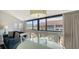 Bright dining area with glass-top table and seating for four, offering courtyard views at 4621 Gulf Of Mexico Dr # 16B, Longboat Key, FL 34228