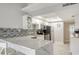 Modern kitchen boasts white cabinets, quartz counters, and stainless steel appliances at 4621 Gulf Of Mexico Dr # 16B, Longboat Key, FL 34228