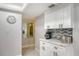 White kitchen cabinets, quartz countertops and breakfast bar area at 4621 Gulf Of Mexico Dr # 16B, Longboat Key, FL 34228