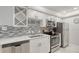 Updated kitchen with white shaker cabinets, quartz countertops and stainless steel appliances at 4621 Gulf Of Mexico Dr # 16B, Longboat Key, FL 34228