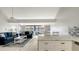 Open living room with comfortable seating, tile floors, and access to balcony at 4621 Gulf Of Mexico Dr # 16B, Longboat Key, FL 34228