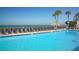 Inviting pool area with ocean views and lounge chairs at 4621 Gulf Of Mexico Dr # 16B, Longboat Key, FL 34228