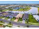 Wide aerial view of a neighborhood featuring tile roofs, lakes, and manicured landscaping at 4925 Surfside Cir, Bradenton, FL 34211