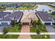 Aerial shot of single Gathering house, showing the tile roof, paver driveway, and lush landscaping at 4925 Surfside Cir, Bradenton, FL 34211