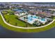 Aerial view of community pool and clubhouse with tennis courts and lush landscaping at 4925 Surfside Cir, Bradenton, FL 34211