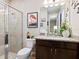 Cozy bathroom features a shower, flamingo art, granite countertops, and dark wood cabinets at 4925 Surfside Cir, Bradenton, FL 34211