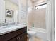This bathroom features a shower/tub combo with decorative wall hangings and a granite countertop at 4925 Surfside Cir, Bradenton, FL 34211