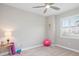 Bright bedroom with a ceiling fan, beach decor, and windows with natural light at 4925 Surfside Cir, Bradenton, FL 34211