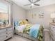 Comfortable bedroom with a ceiling fan, tropical decor, and windows with natural light at 4925 Surfside Cir, Bradenton, FL 34211