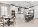 Open-concept kitchen with a large island, modern appliances, and an adjacent dining area at 4925 Surfside Cir, Bradenton, FL 34211