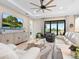 Comfortable living room overlooking a pond, with a large TV and plenty of seating at 4925 Surfside Cir, Bradenton, FL 34211