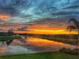 Beautiful sunset over the water, with orange and yellow hues reflecting on the calm surface at 4925 Surfside Cir, Bradenton, FL 34211
