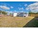 Spacious backyard with shed and wooden fence, under a blue sky at 5033 La Copa St, North Port, FL 34287