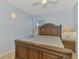 Cozy bedroom with light blue walls, wooden furniture, and plenty of natural light at 5033 La Copa St, North Port, FL 34287