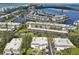 Aerial view of waterfront community with pool and marina at 549 Sutton Pl, Longboat Key, FL 34228