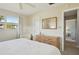 Main bedroom with a queen bed, dresser, and access to another room at 549 Sutton Pl # T19, Longboat Key, FL 34228