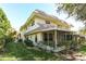 Building exterior showcasing a screened porch and well-manicured landscaping at 549 Sutton Pl, Longboat Key, FL 34228