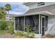 Inviting screened porch with lush landscaping at 549 Sutton Pl, Longboat Key, FL 34228