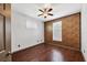 Charming bedroom with ceiling fan, wood floors, bright windows, and patterned accent wall at 5581 Key West Pl # 5581, Bradenton, FL 34203