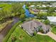 Beautiful waterfront home with lush landscaping, screened-in lanai, and a private boat dock on the canal at 609 Colonial Bay Dr, Nokomis, FL 34275