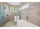 Contemporary bathroom with a soaking tub and glass enclosed shower at 609 Colonial Bay Dr, Nokomis, FL 34275