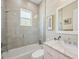 Bright bathroom featuring a window, glass shower, and a marble vanity at 609 Colonial Bay Dr, Nokomis, FL 34275
