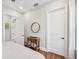 Bright bedroom with wood floors featuring a decorative table, mirror, and white doors at 609 Colonial Bay Dr, Nokomis, FL 34275