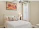 Bedroom featuring light walls, wood floors, ceiling fan, and a large window at 609 Colonial Bay Dr, Nokomis, FL 34275