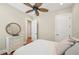 Bedroom featuring light walls, wood floors, and a decorative mirror at 609 Colonial Bay Dr, Nokomis, FL 34275