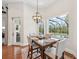 Dining space featuring an outdoor view of the pool and patio through a large window at 609 Colonial Bay Dr, Nokomis, FL 34275