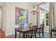 Dining room with a wooden table set on a rug and a colorful painting hanging on the wall at 609 Colonial Bay Dr, Nokomis, FL 34275