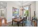 Bright dining room with a wooden table, chandelier, and a window showcasing the outdoor scenery at 609 Colonial Bay Dr, Nokomis, FL 34275