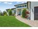 Inviting home with a manicured lawn, stone pathway, and well-maintained landscape leading to a blue front door at 609 Colonial Bay Dr, Nokomis, FL 34275