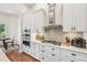 Bright kitchen with white cabinets, stainless steel appliances, and an adjacent dining area at 609 Colonial Bay Dr, Nokomis, FL 34275