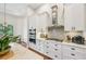 Gourmet kitchen with stainless steel appliances and sleek white cabinetry at 609 Colonial Bay Dr, Nokomis, FL 34275