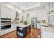 Modern kitchen featuring stainless steel appliances, a central island, and custom cabinetry at 609 Colonial Bay Dr, Nokomis, FL 34275