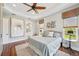 Beautiful main bedroom with tray ceiling, decorative ceiling fan, and views of the water at 609 Colonial Bay Dr, Nokomis, FL 34275