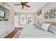 Main bedroom featuring a view into the ensuite bathroom and a built-in media center at 609 Colonial Bay Dr, Nokomis, FL 34275