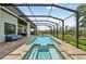 Long, screened-in pool and hot tub with covered patio and outdoor seating at 609 Colonial Bay Dr, Nokomis, FL 34275