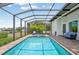 Screened-in pool with outdoor seating and brick deck at 609 Colonial Bay Dr, Nokomis, FL 34275