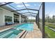 Long, screened-in pool with hot tub, patio and outdoor seating area at 609 Colonial Bay Dr, Nokomis, FL 34275
