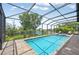 Screened-in pool with outdoor seating and lush waterfront view at 609 Colonial Bay Dr, Nokomis, FL 34275