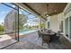 Screened-in pool with outdoor dining, seating, and beautiful waterfront view at 609 Colonial Bay Dr, Nokomis, FL 34275