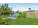 Scenic waterfront view with a private dock, lush greenery, and a serene atmosphere at 609 Colonial Bay Dr, Nokomis, FL 34275