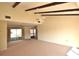 Large living room with wood beams and sliding glass doors at 6564 Draw Ln # 102, Sarasota, FL 34238