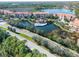 Aerial view showing community, lake, and road at 7702 Lake Vista Ct # 306, Lakewood Ranch, FL 34202