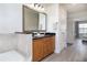 Modern bathroom with double vanity, large mirror, and wood cabinets at 7702 Lake Vista Ct # 306, Lakewood Ranch, FL 34202