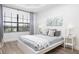 Comfortable bedroom with a queen-size bed, large windows, and neutral decor at 7702 Lake Vista Ct # 306, Lakewood Ranch, FL 34202
